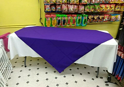 White table cloth with purple diamond on top.