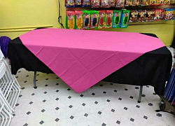 Black table cloth with hot pink diamond on top.